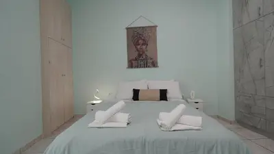 a white bedroom with a large bed with white pillows at Maria's Ethereal Place in Athens