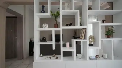 a white book shelf with figurines and plants on it at Maria's Ethereal Place in Athens