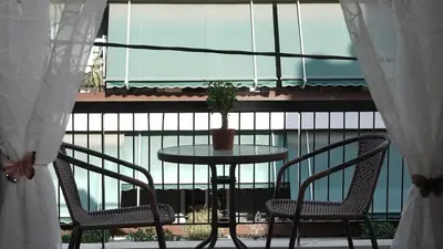 a table and two chairs on a balcony at Maria's Ethereal Place in Athens