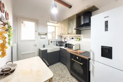 a kitchen with a white refrigerator and a sink at Comfort Athens Apartment near Metro Station in Athens