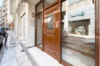 a door to a store on a city street at Comfort Athens Apartment near Metro Station in Athens