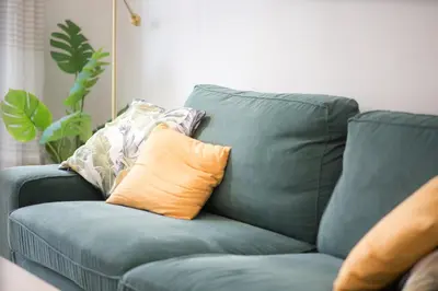 a blue couch with pillows on it in a living room at Comfort Athens Apartment near Metro Station in Athens