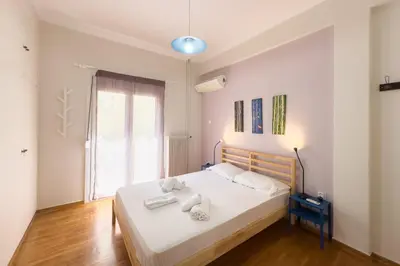 a bedroom with a white bed with towels on it at Comfort Athens Apartment near Metro Station in Athens