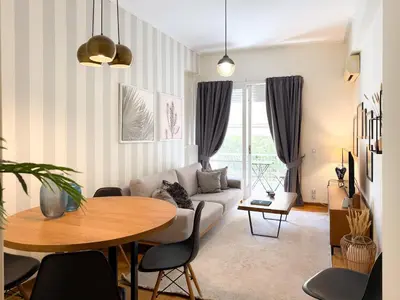 a living room with a couch and a table at Achaiou Apartment Kolonaki in Athens