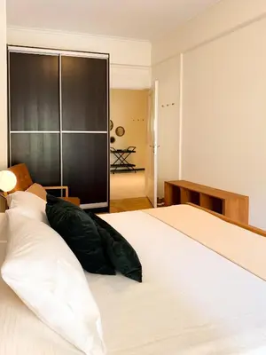 a bedroom with a large bed with a pillow on it at Achaiou Apartment Kolonaki in Athens