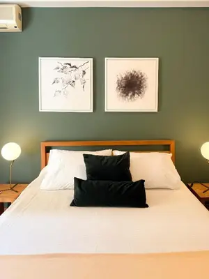 a bedroom with a white bed with two pillows at Achaiou Apartment Kolonaki in Athens