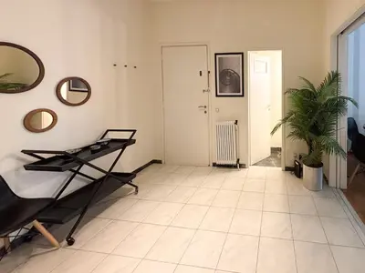 a room with a table and a mirror and a plant at Achaiou Apartment Kolonaki in Athens