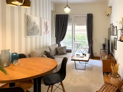 a living room with a table and a couch at Achaiou Apartment Kolonaki in Athens