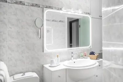 a bathroom with a sink and a mirror and a toilet at Pure Azure in Athens