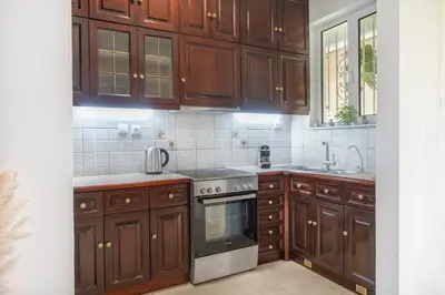 a kitchen with wooden cabinets and a stove at Pure Azure in Athens