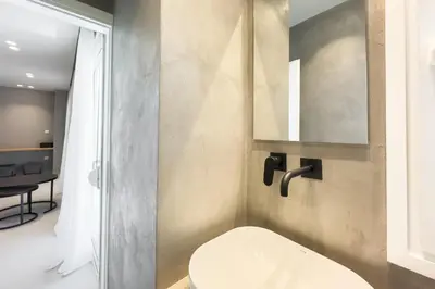 a bathroom with a white toilet and a mirror at City Beat Athens Studio in Athens