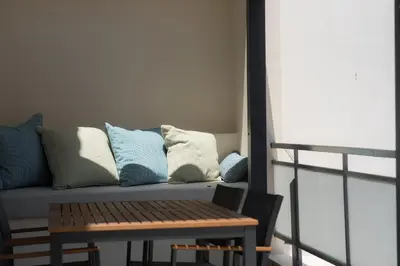 a couch with pillows on it next to a table at City Beat Athens Studio in Athens
