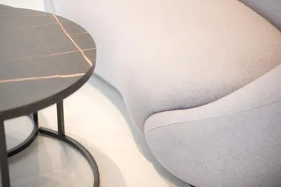 a close up of a gray chair and a table at City Beat Athens Studio in Athens