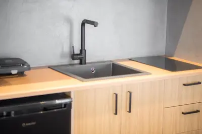 a kitchen counter with a sink and a stove at City Beat Athens Studio in Athens