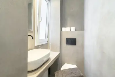 a white bathroom with a sink and a mirror at City Beat Athens Studio in Athens