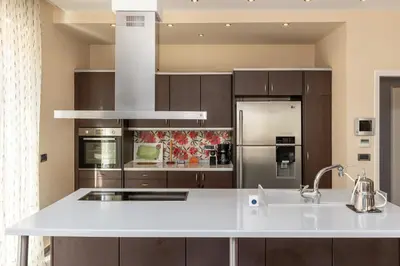 a kitchen with a white counter top and a refrigerator at Vasso Villa in Vravrona