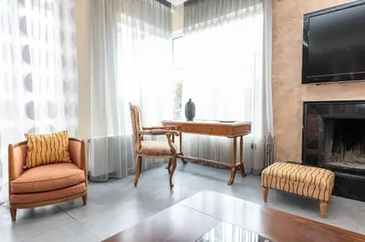 a living room with a desk and a fireplace at Vasso Villa in Vravrona