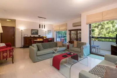 a living room with couches and a table at Seaside Apartment in Palaio Faliro in Athens