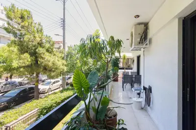 a balcony of a building with plants and a street at Seaside Apartment in Palaio Faliro in Athens