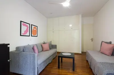 a living room with two couches and a table at Seaside Apartment in Palaio Faliro in Athens