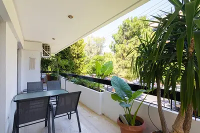 a balcony with a table and chairs and plants at Seaside Apartment in Palaio Faliro in Athens