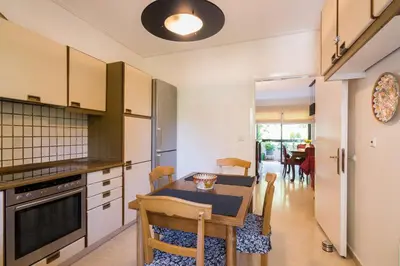a kitchen with a table and a dining room at Seaside Apartment in Palaio Faliro in Athens
