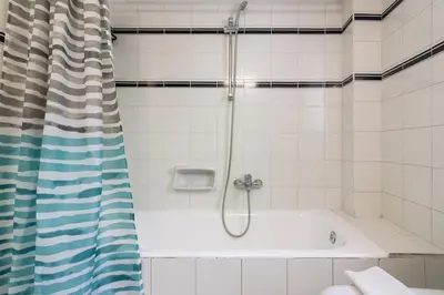 a bathroom with a shower with a tub at Seaside Apartment in Palaio Faliro in Athens