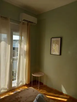 a room with a table and a window with a stool at Αpt in Gazi in front of metro in Athens