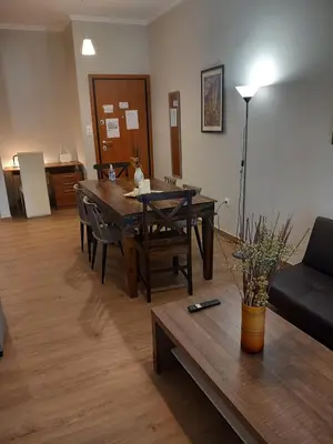 a living room with a table and a couch at Αpt in Gazi in front of metro in Athens