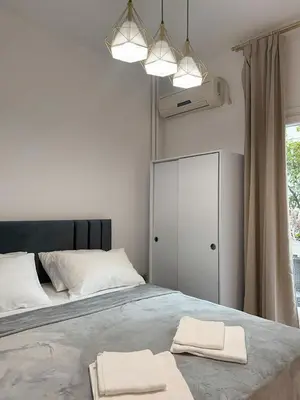 a bedroom with a bed with two towels on it at Ridis Studio Athens in Athens