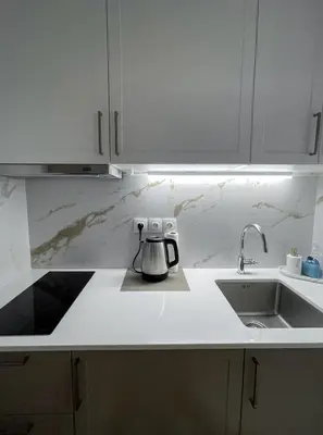 a kitchen with a sink and a coffee pot on a counter at Ridis Studio Athens in Athens