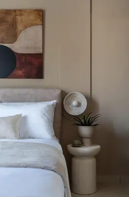a bedroom with a bed and a plant on a side table at Acropolis Atelier, Plunge Pool Apartments in Athens