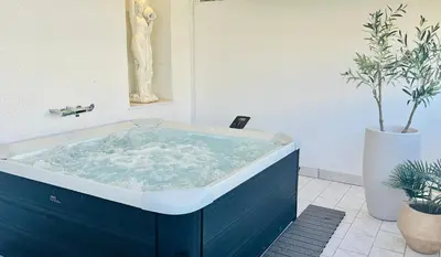 a blue tub in a bathroom with a plant at Acropolis Atelier, Plunge Pool Apartments in Athens