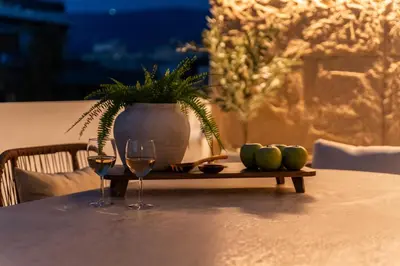 a table with two wine glasses and a potted plant at Acropolis Atelier, Plunge Pool Apartments in Athens