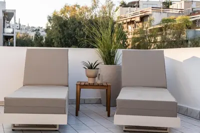 two chairs on a balcony with a table at Acropolis Atelier, Plunge Pool Apartments in Athens