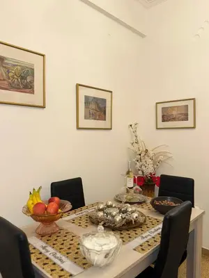 a dining room table with a bowl of fruit on it at Casa Esmeralda Faliro in Athens