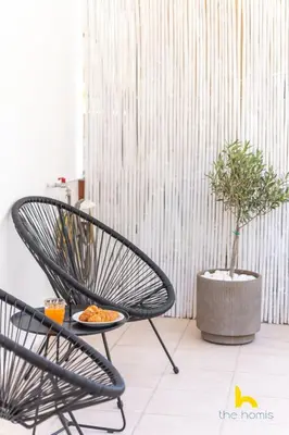 a black chair and a plate of food on a table at Athens Riviera APT, Near Seaside with Private Parking in Athens