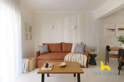 a living room with a couch and a table at Athens Riviera APT, Near Seaside with Private Parking in Athens