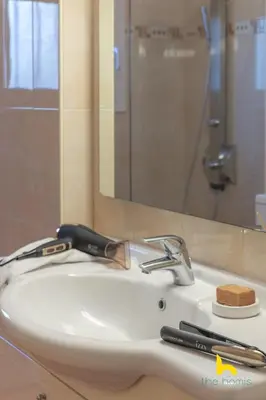 a bathroom sink with a blow dryer and a razor at Athens Riviera APT, Near Seaside with Private Parking in Athens