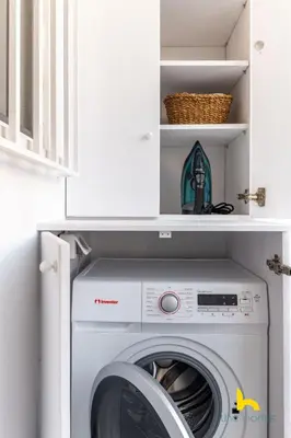 a laundry room with a washer and dryer in a cabinet at Athens Riviera APT, Near Seaside with Private Parking in Athens