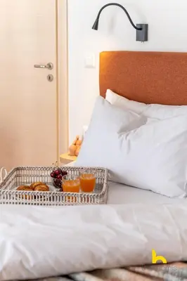 a tray of food sitting on top of a bed at Athens Riviera APT, Near Seaside with Private Parking in Athens