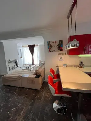 a bedroom with a bed and a kitchen with a table at Apartment Glyfada Athens at One o One Seven, bright and spacious apartment located on the first floor with no elevator in Athens