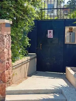 a blue door with a no parking sign on it at Apartment Glyfada Athens at One o One Seven, bright and spacious apartment located on the first floor with no elevator in Athens