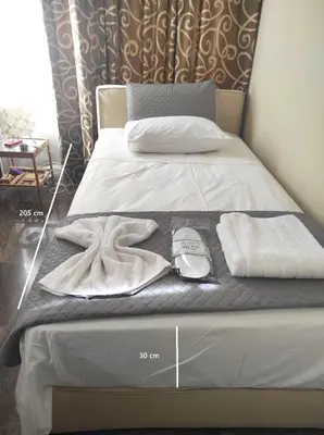 a bedroom with a bed with a clock on it at Apartment Glyfada Athens at One o One Seven, bright and spacious apartment located on the first floor with no elevator in Athens