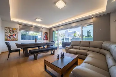 a living room with a couch and a table at Anlijors Premium Residency in Kalívia Thorikoú