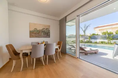 a dining room with a table and chairs at Anlijors Premium Residency in Kalívia Thorikoú