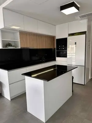 a kitchen with white cabinets and a black counter top at Elizabeth's in Athens