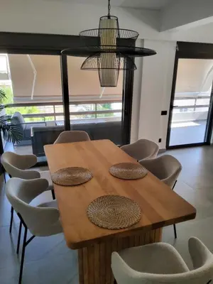 a wooden table and chairs in a room at Elizabeth's in Athens