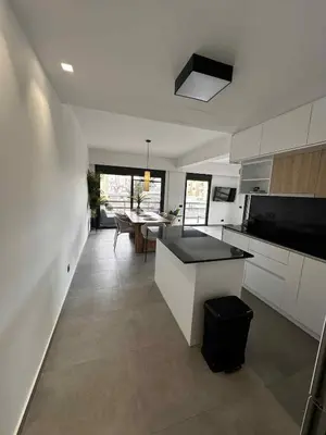 a kitchen with a island in the middle of a room at Elizabeth's in Athens