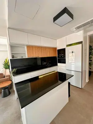 a kitchen with white cabinets and a black counter top at Elizabeth's in Athens